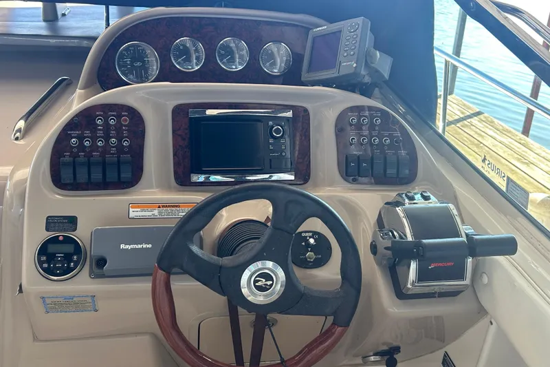 Slide: The Image of White leather seating on a 2005 Sea Ray 300 Sundancer boat. - 13