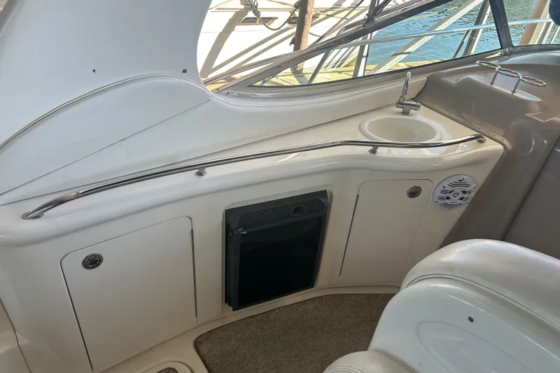Slide: The Image of White leather seating on a 2005 Sea Ray 300 Sundancer boat. - 14