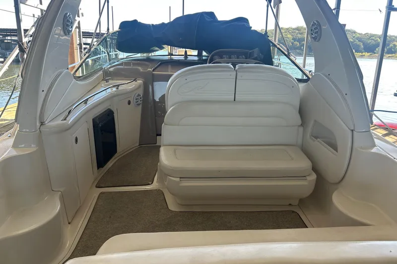 Slide: The Image of Control panel of a 2005 Sea Ray 300 Sundancer boat with steering wheel and navigation instruments. - 15