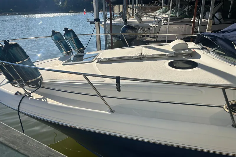 Slide: The Image of 2005 Sea Ray 300 Sundancer boat interior with sink and storage cabinets. - 16