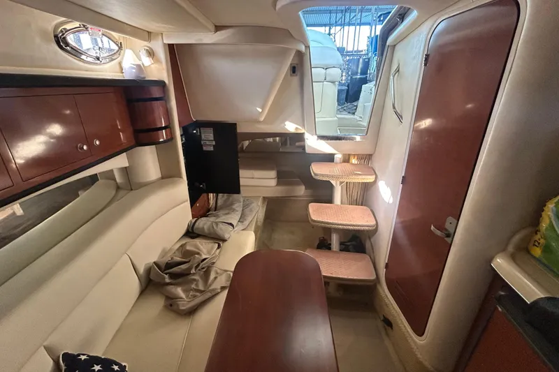 Slide: The Image of 2005 Sea Ray 300 Sundancer cabin interior with beige seating and carpet. - 7