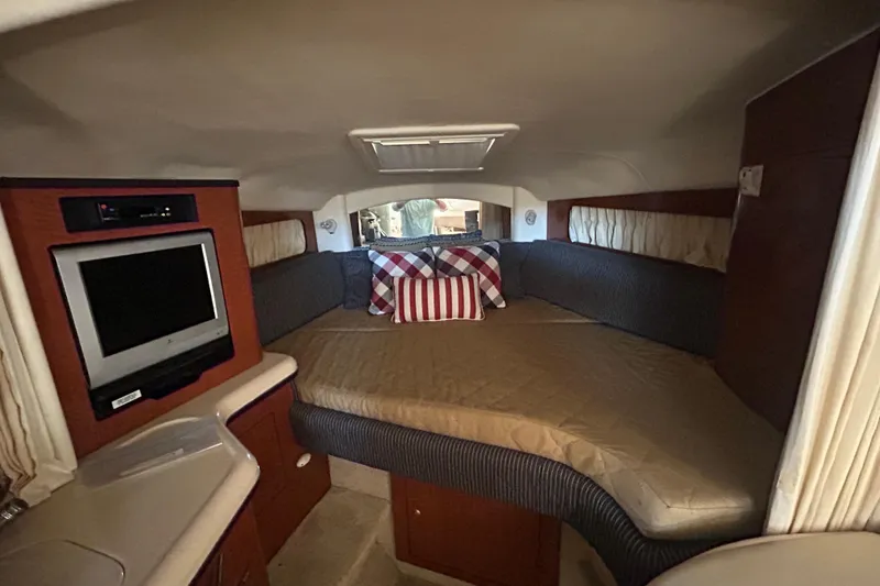 Slide: The Image of Interior of 2005 Sea Ray 300 Sundancer yacht with seating and wooden cabinetry. - 9