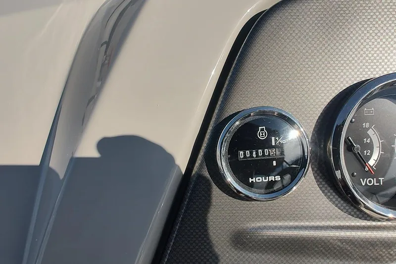 Slide: The Image of Close-up of 2024 Crest Classic LX 220 dashboard gauges, showing hours and voltage meters. - 8