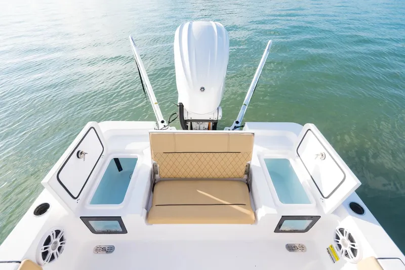 Slide: The Image of 2026 Sportsman Masters 247 Bay Boat with tan seating and open storage compartments. - 12