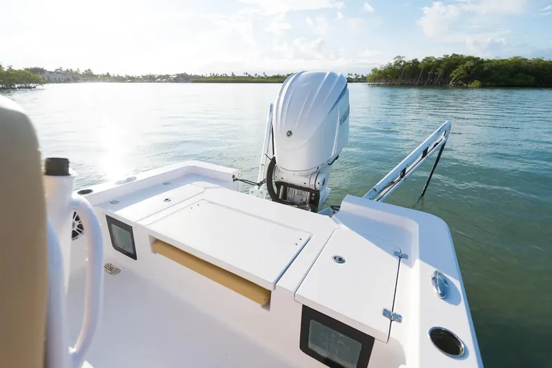 Slide: The Image of 2026 Sportsman Masters 247 Bay Boat on calm water, featuring a powerful outboard motor. - 13