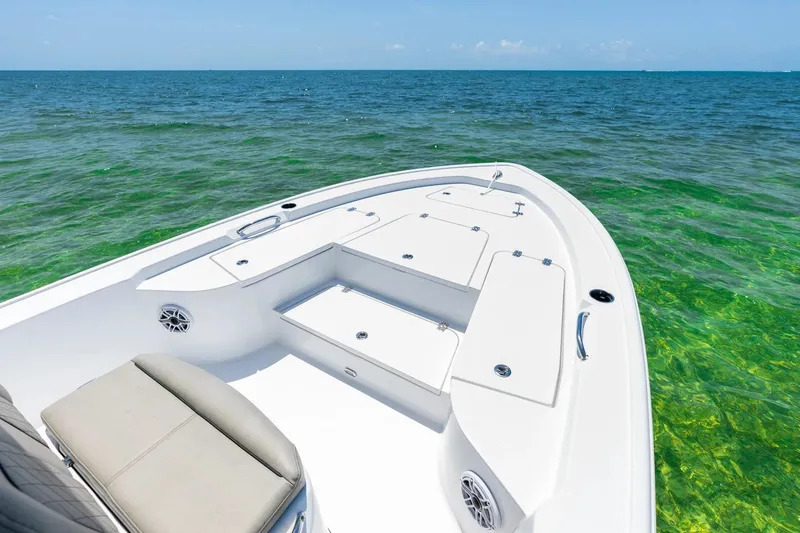 Slide: The Image of 2026 Sportsman Masters 247 Bay Boat on clear ocean water, showcasing spacious deck. - 2