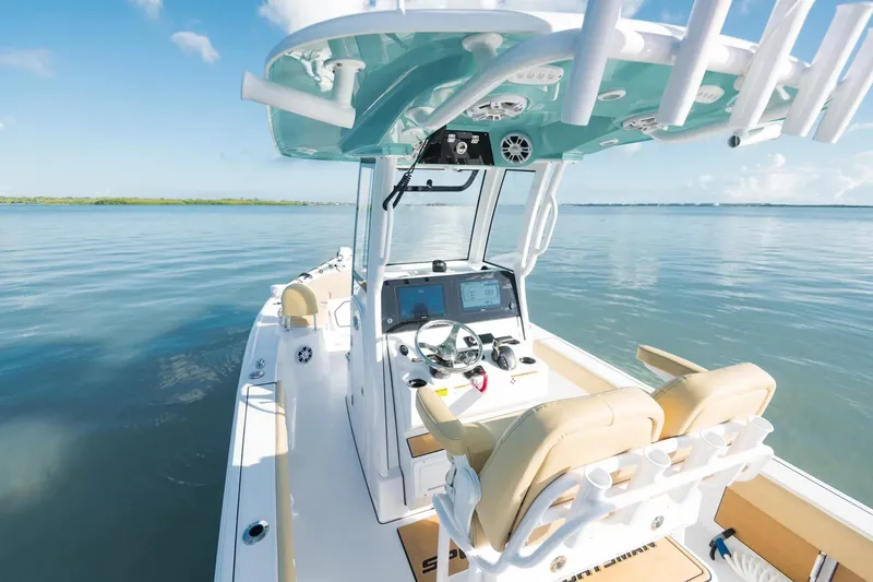 Slide: The Image of 2026 Sportsman Masters 247 Bay Boat on calm water, featuring modern helm and seating. - 8