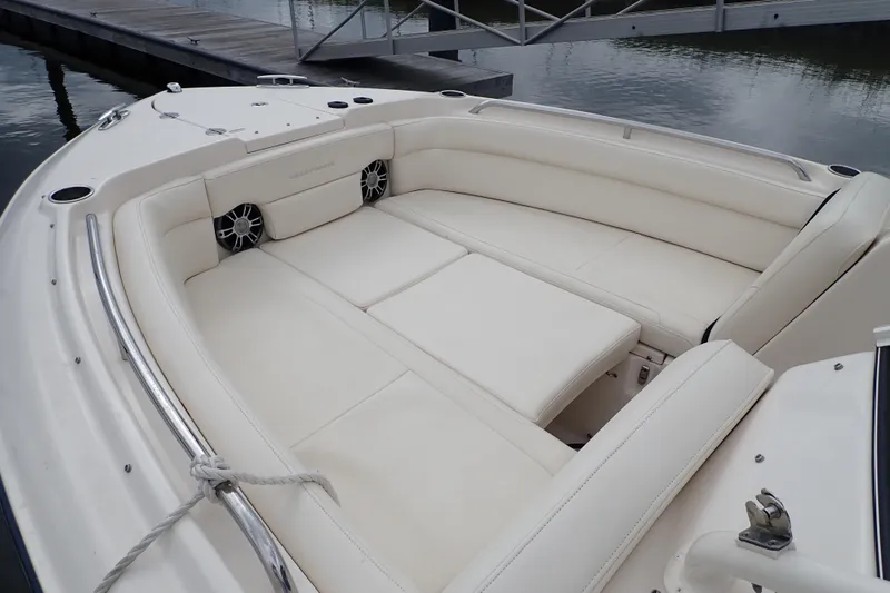 Slide: The Image of 2021 Grady-White Freedom 275 boat with spacious white seating area at dock. - 10