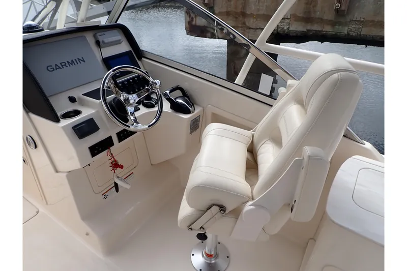 Slide: The Image of 2021 Grady-White Freedom 275 boat helm with Garmin navigation and plush captain's chair. - 12