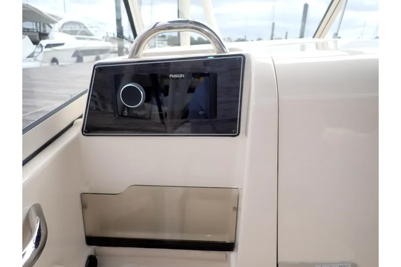Slide: The Image of 2021 Grady-White Freedom 275 boat dashboard with Fusion audio system. - 21
