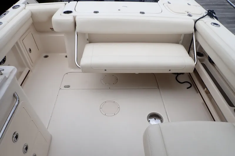 Slide: The Image of 2021 Grady-White Freedom 275 boat interior with white seating and storage compartments. - 24