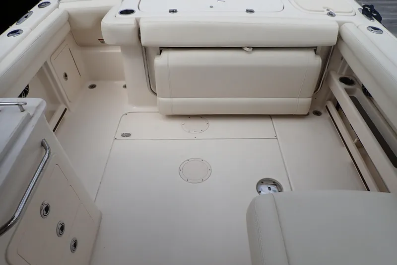 Slide: The Image of 2021 Grady-White Freedom 275 boat interior with beige seating and storage compartments. - 25