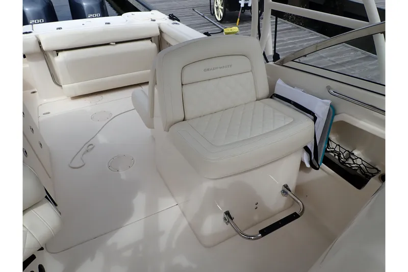 Slide: The Image of 2021 Grady-White Freedom 275 boat interior with cushioned seating and storage. - 29