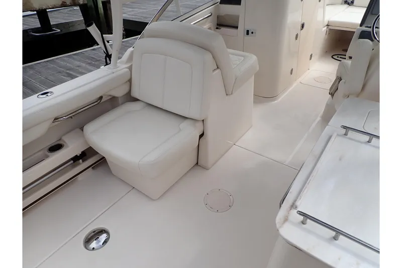 Slide: The Image of 2021 Grady-White Freedom 275 boat interior with white seating and sleek design. - 30