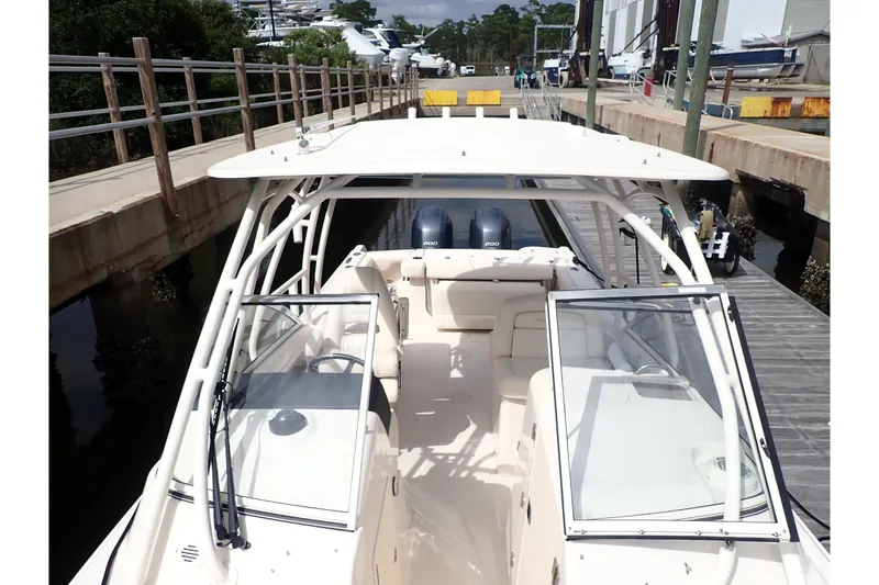 Slide: The Image of 2021 Grady-White Freedom 275 boat docked, featuring dual engines and spacious seating. - 31