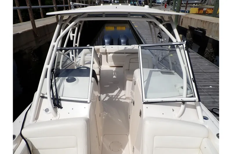 Slide: The Image of 2021 Grady-White Freedom 275 boat interior with open windshield, docked at marina. - 32