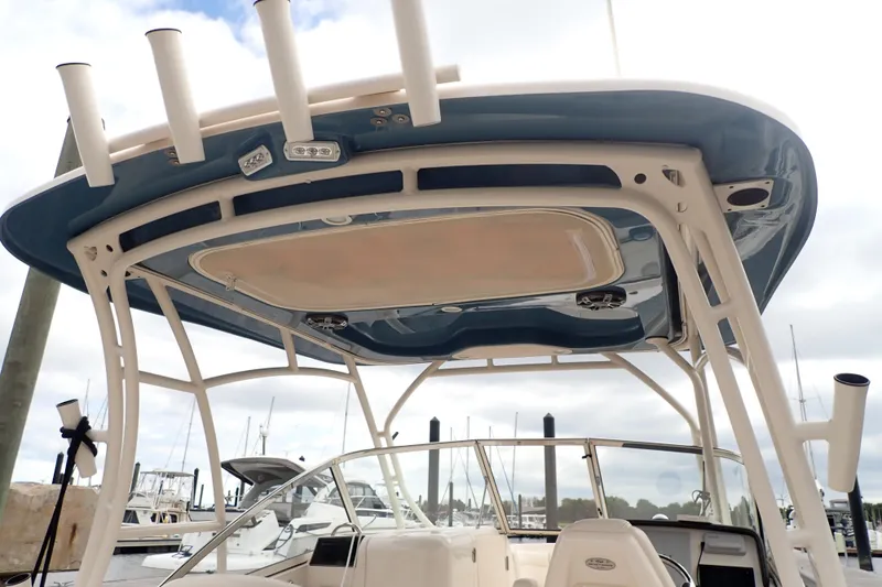 Slide: The Image of 2021 Grady-White Freedom 275 boat with blue hardtop and rod holders at marina. - 33