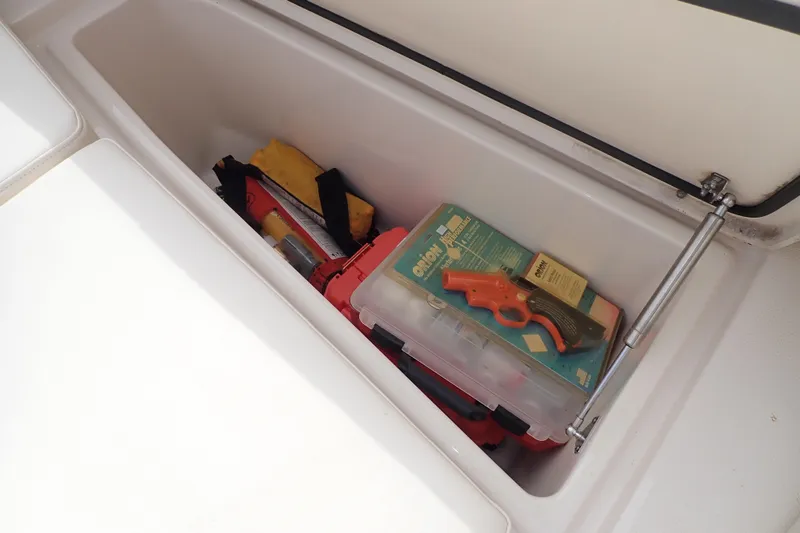 Slide: The Image of Storage compartment on 2021 Grady-White Freedom 275 boat with safety equipment and tools. - 42