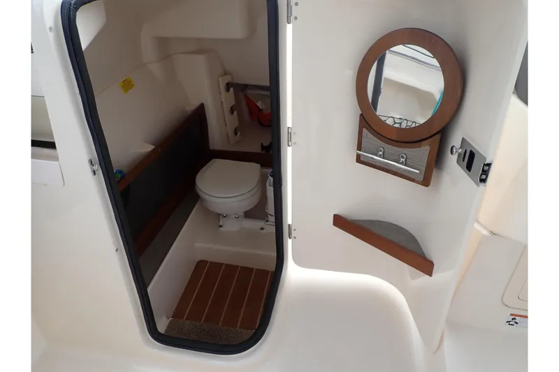 Slide: The Image of 2021 Grady-White Freedom 275 boat interior with toilet and mirror. - 43