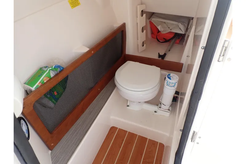 Slide: The Image of 2021 Grady-White Freedom 275 boat interior with toilet and storage area. - 45
