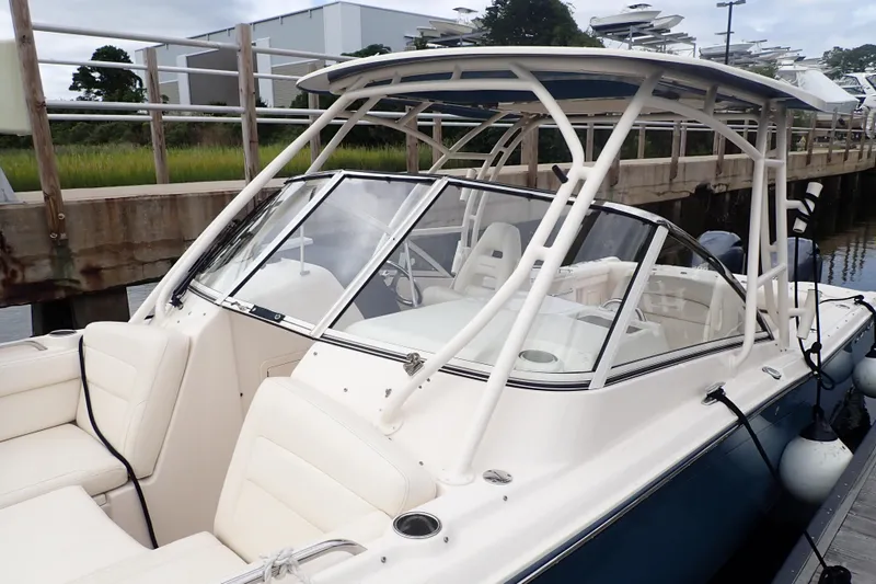 Slide: The Image of 2021 Grady-White Freedom 275 boat docked, featuring sleek design and comfortable seating. - 7