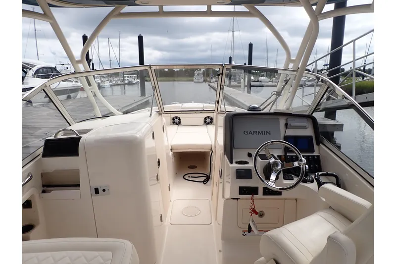 Slide: The Image of 2021 Grady-White Freedom 275 boat interior with Garmin navigation system at marina. - 8