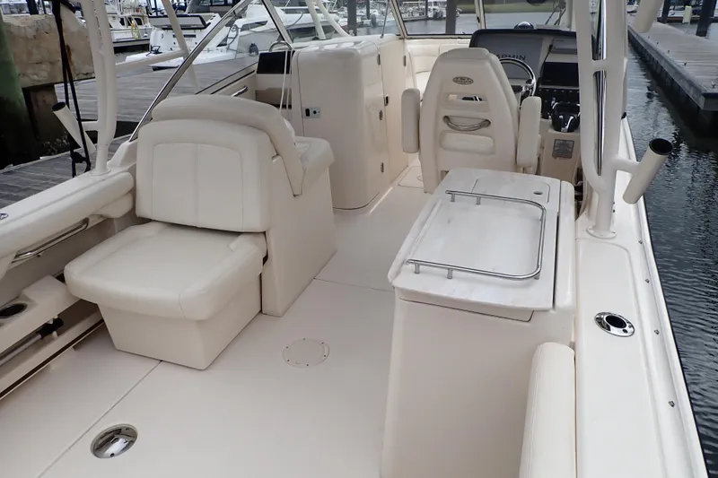 Slide: The Image of 2021 Grady-White Freedom 275 boat interior with white seating and helm station. - 9