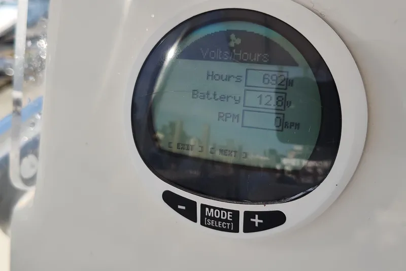 Slide: The Image of Digital display on 2023 Cobia 237 Center Console showing hours, battery voltage, and RPM. - 12