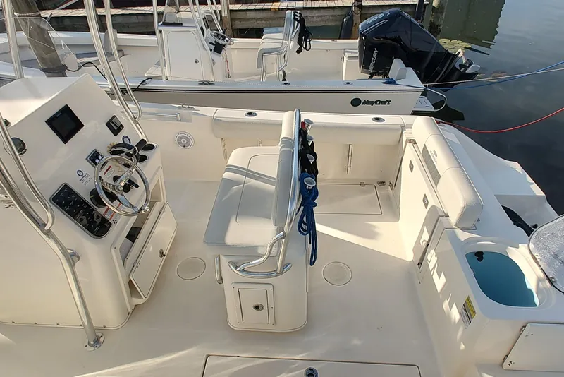 Slide: The Image of 2023 Cobia 237 Center Console boat interior with helm, seating, and storage. - 4