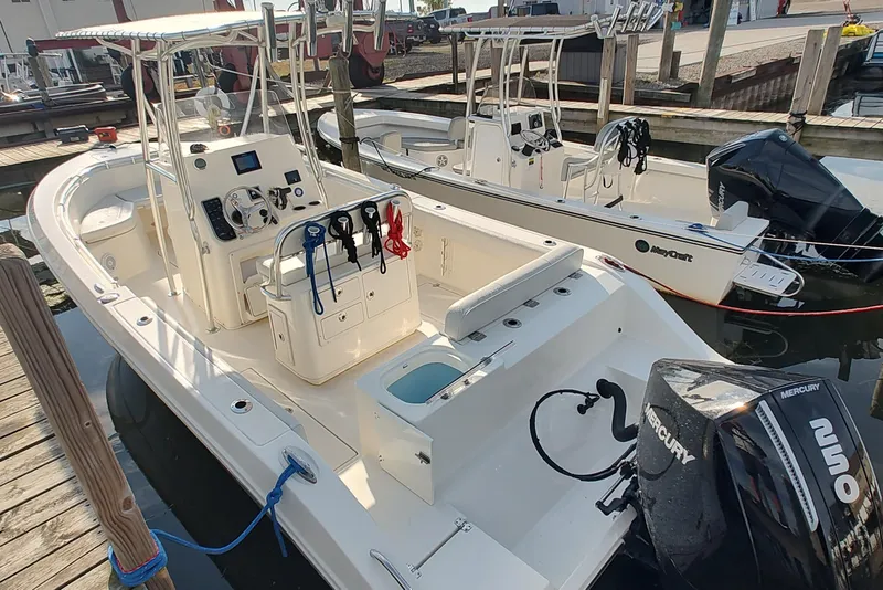 Slide: The Image of 2023 Cobia 237 Center Console boat docked with Mercury engine, featuring modern controls. - 5