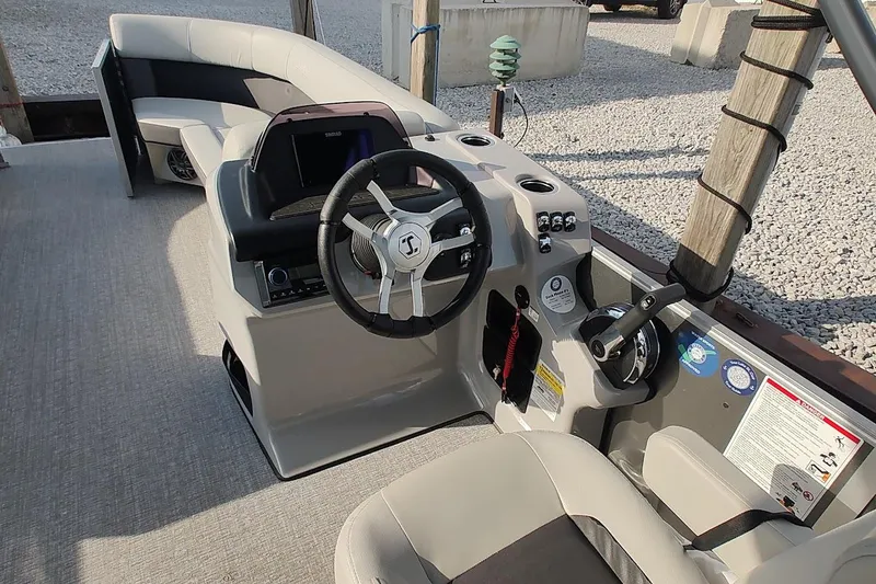 Slide: The Image of 2024 Harris Cruiser 230 boat interior with steering wheel and control panel. - 10