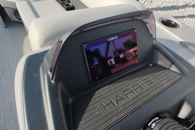Slide: The Image of 2024 Harris Cruiser 230 dashboard with Simrad display and comfortable seating. - 7