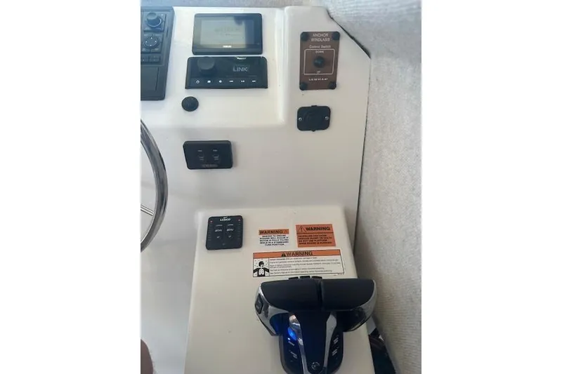 Slide: The Image of Control panel of 2022 Parker 2520 XLD Sport Cabin boat with various switches and warnings. - 10