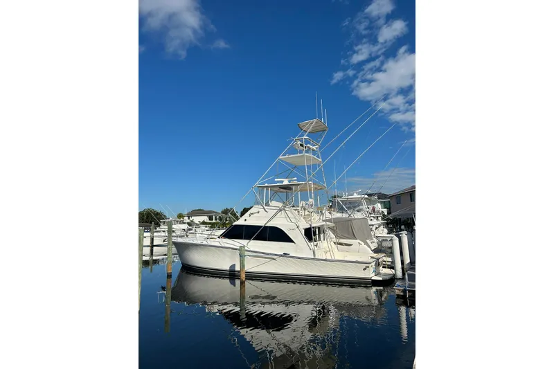 Slide: The Image of 1988 Ocean Yachts 48 Super Sport docked under clear blue sky. - 0