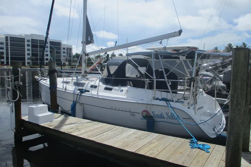 The Image of 2003 Hunter 356 sailboat docked at marina with clear sky background. - 1