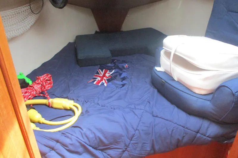 Slide: The Image of Cozy cabin interior of 2003 Hunter 356 sailboat with nautical accessories and bedding. - 14