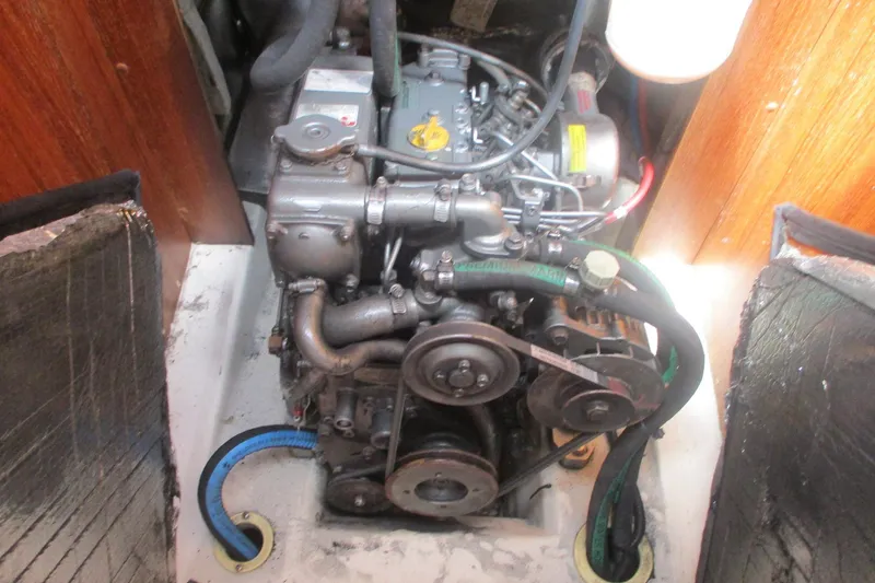 Slide: The Image of Engine compartment of a 2003 Hunter 356 sailboat, showcasing mechanical components and hoses. - 17