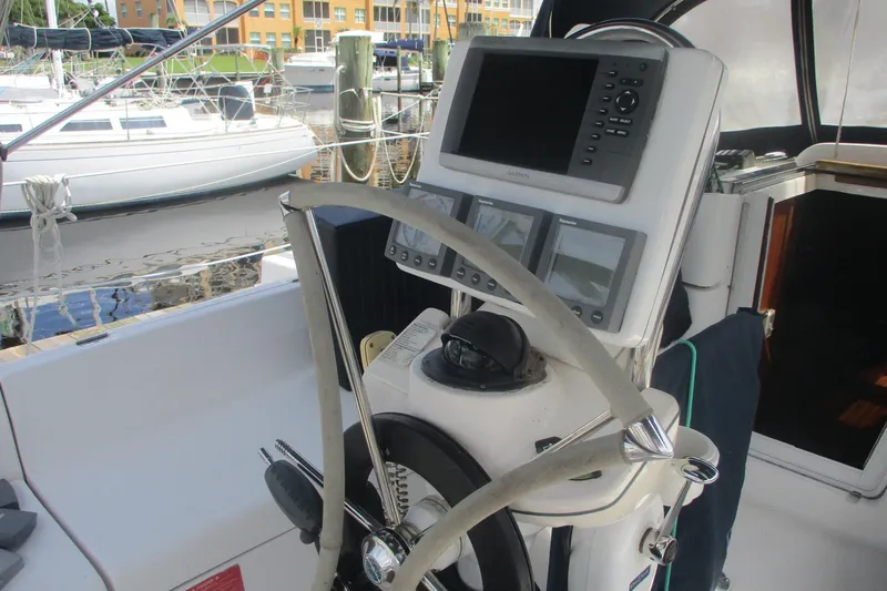 Slide: The Image of Steering console of 2003 Hunter 356 sailboat with navigation equipment at marina. - 21