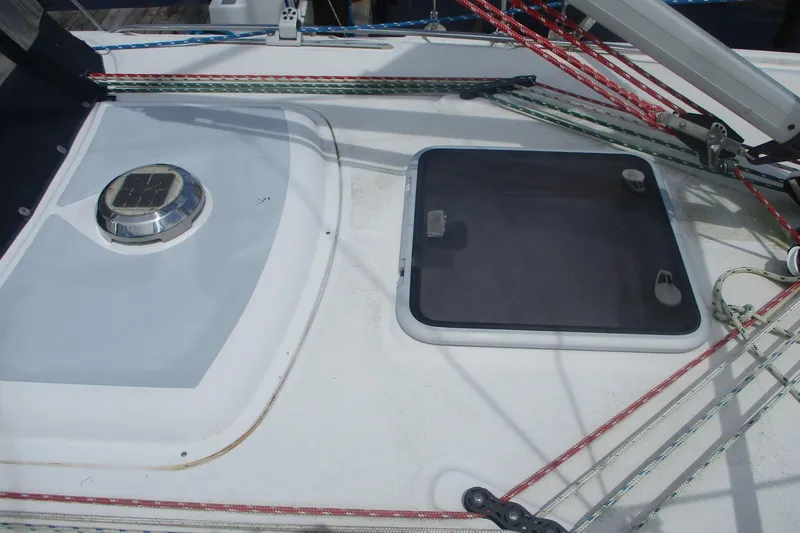 Slide: The Image of Deck of 2003 Hunter 356 sailboat with hatch and colorful rigging ropes. - 25