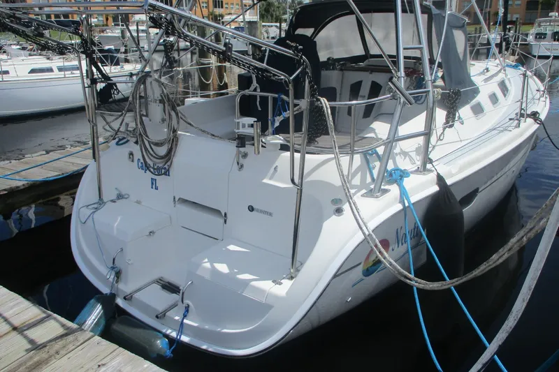 Slide: The Image of Hunter 356 sailboat, 2003 model, docked at marina with ropes and equipment. - 3