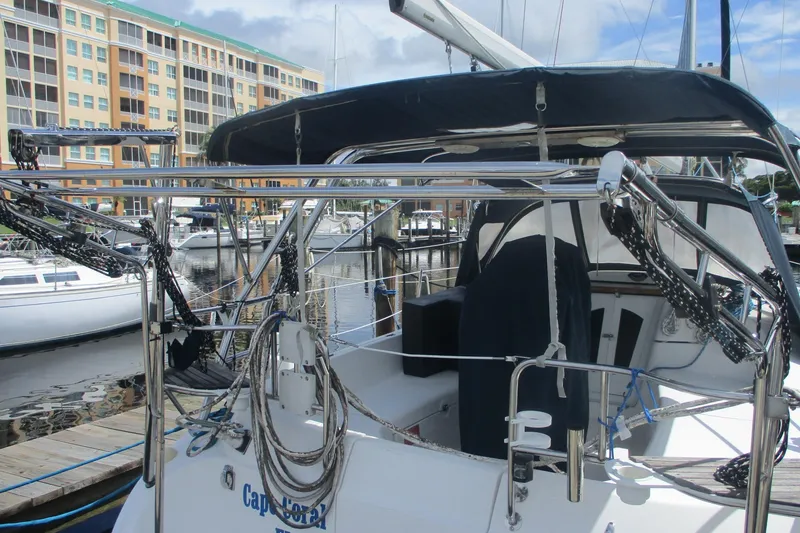 Slide: The Image of 2003 Hunter 356 sailboat docked at marina with modern rigging and covered cockpit. - 4