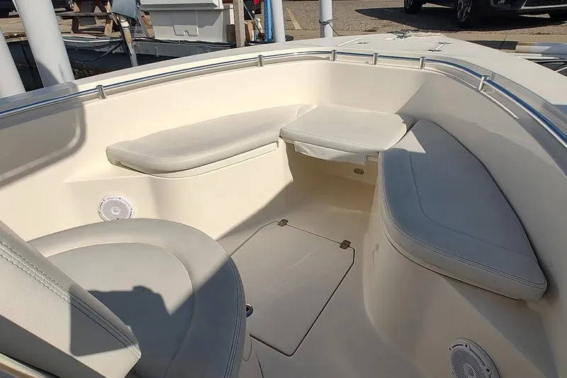 Slide: The Image of 2023 Cobia 237 Center Console boat interior with cushioned seating and storage compartments. - 16