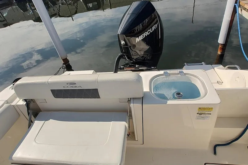 Slide: The Image of 2023 Cobia 237 Center Console boat with Mercury engine and onboard sink. - 6