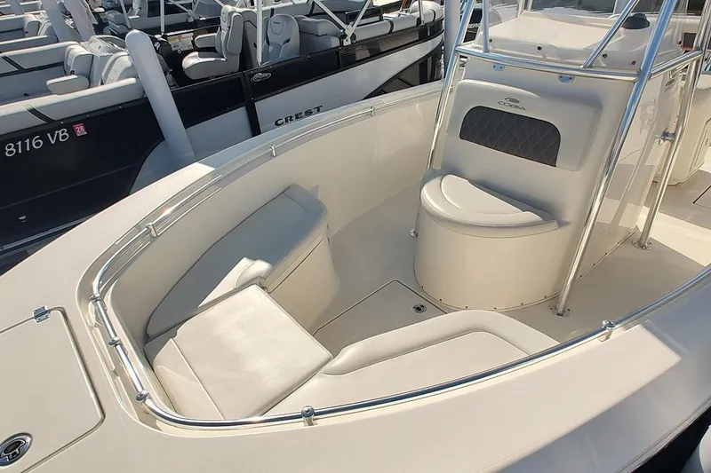 Slide: The Image of 2023 Cobia 237 Center Console boat interior with cushioned seating and sleek design. - 9
