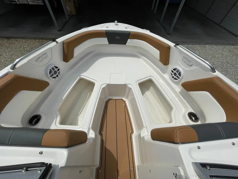 Slide: The Image of 2026 Chaparral 21 SSi boat interior with white and brown seating, open windshield. - 10