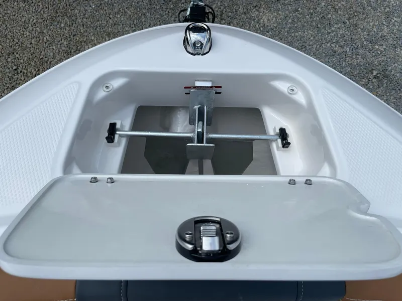 Slide: The Image of 2026 Chaparral 21 SSi boat interior with brown and black cushioned seating. - 11