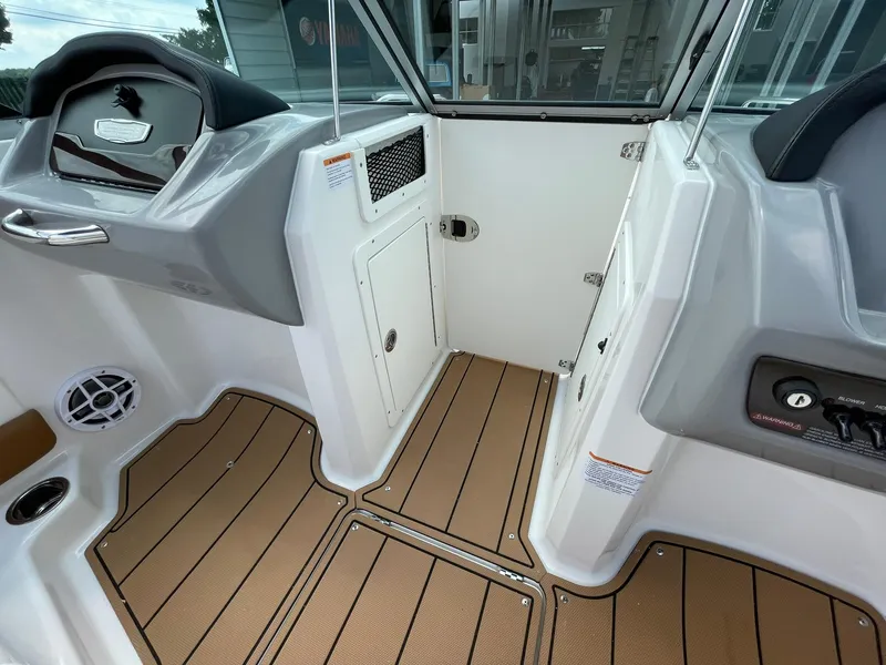 Slide: The Image of 2026 Chaparral 21 SSi boat dashboard with steering wheel and control panel. - 15