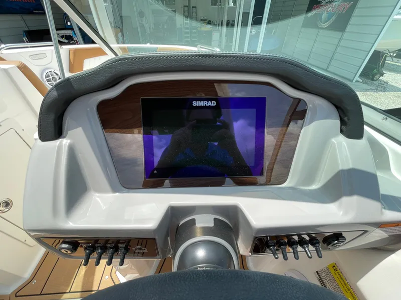 Slide: The Image of 2026 Chaparral 21 SSi boat interior with modern helm and seating. - 19