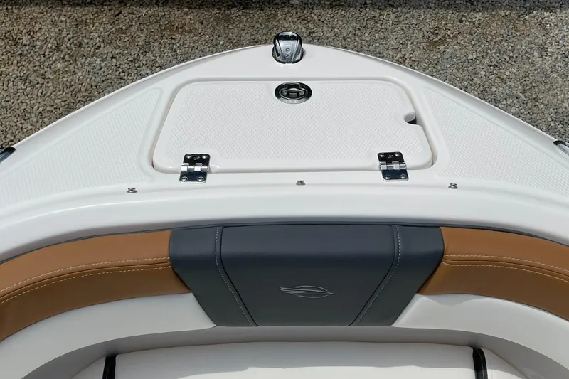 Slide: The Image of 2026 Chaparral 21 SSi boat with sleek design and black canopy against clear blue sky. - 2