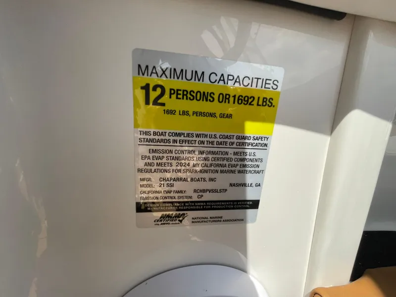 Slide: The Image of 2026 Chaparral 21 SSi boat interior with open storage compartment and sleek design. - 21